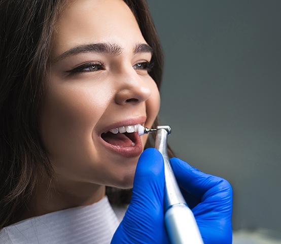 Female patient receiving a dental cleaning