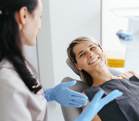 Dentist talking to a female patient