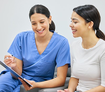 Dental team member discussing dental insurance with a patient