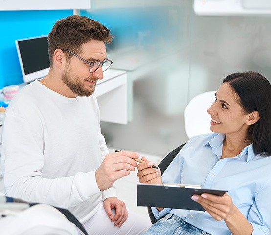 Female patient smiling at her dentist