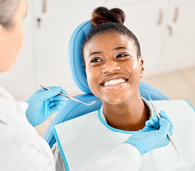 Woman smiling at dentist during exam