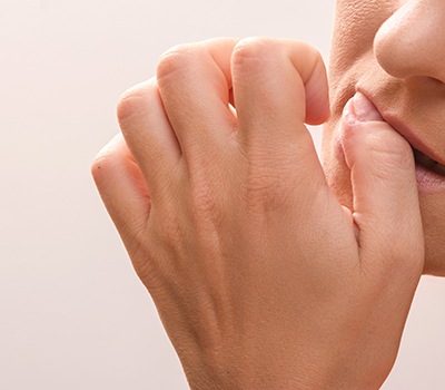 Closeup of person biting their nails