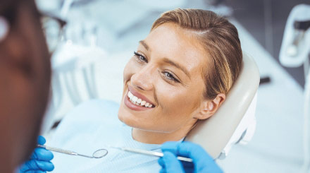 female-dental-patient-smiling-during-dental-exam